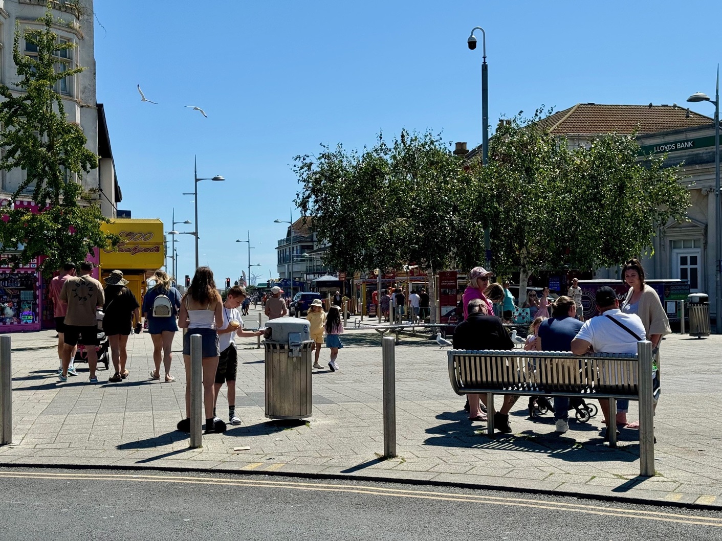 Residents in the Clacton Town Centre conversing on a bench