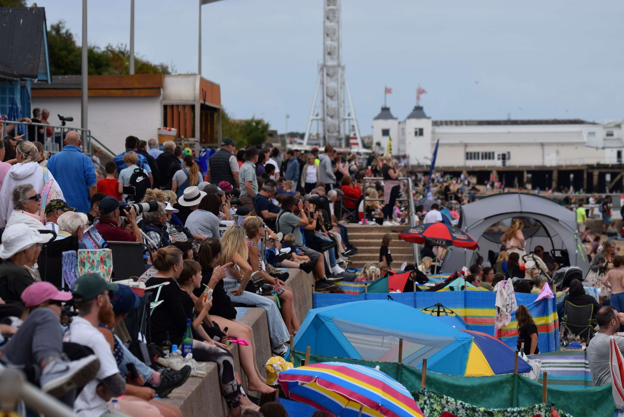 Crowds sit along Clacton Beach to watch the Clacton Airshow 2025.