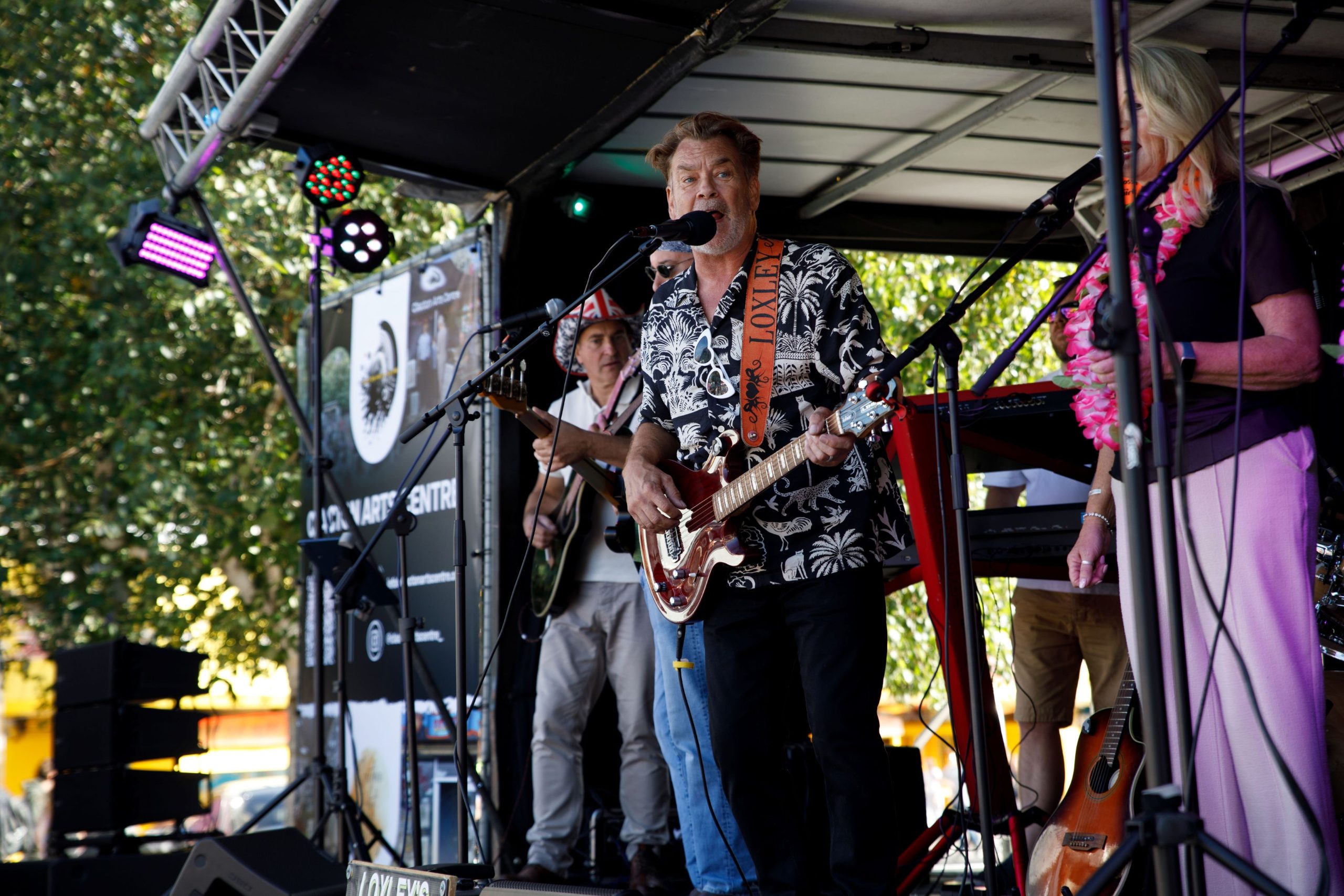 Band performing on stage at Love Claton Day event